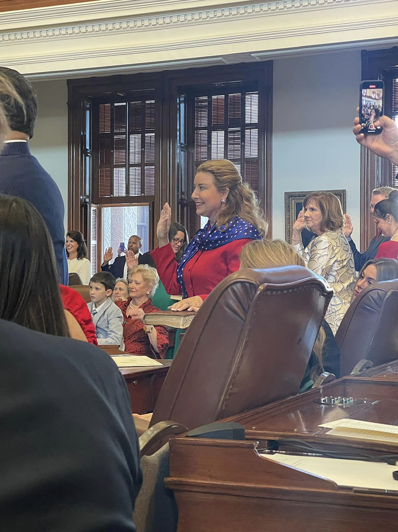 State Representative Terri Leo Wilson takes the Oath of Office surrounded by her family during the Opening Day Ceremony.